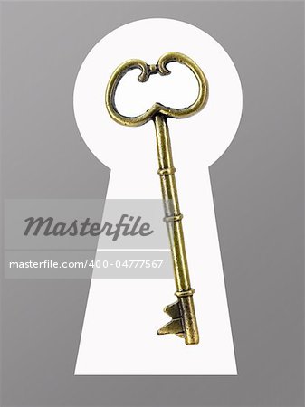 A vintage brass key isolated against a white background