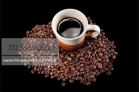 Coffee cup and beans on black background