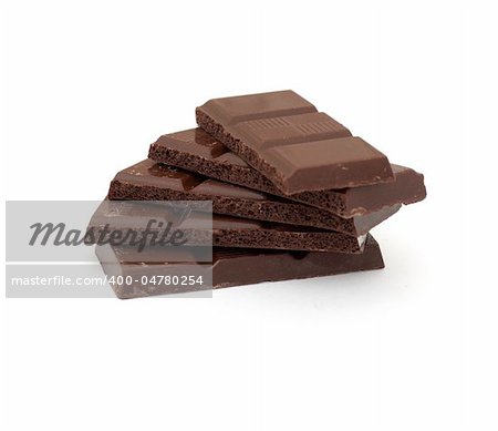 dark chocolate pieces isolated on white background
