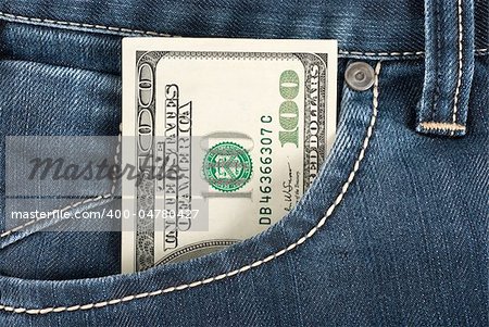 A one hundred dollar note in the front pocket of denim trousers