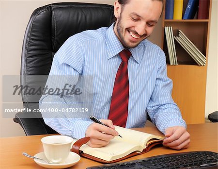 Businessman at office working at his workplace.
