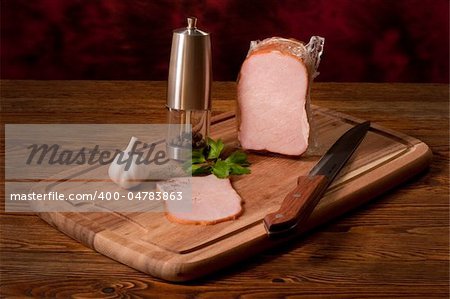 Composition with smoked vacuum packed ham on the table