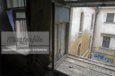 View through window in abandoned house to backyard
