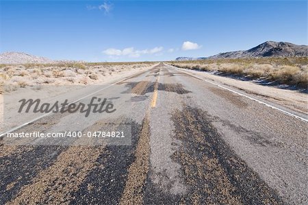 Muddy road through a winter desert scene, Mojave National Preserve, California