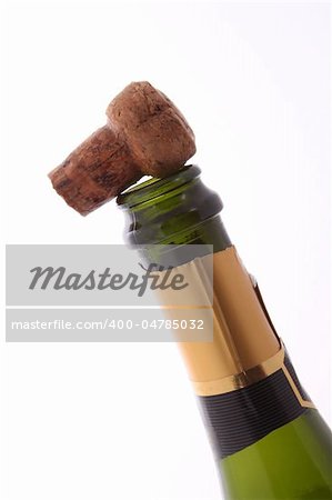 Champagne bottle and cork  on a plain white background.