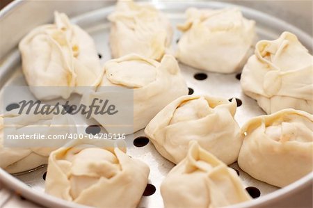 Oriental dumplings (manty) in metall steam cooker