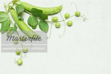 Green peas composition on linen background