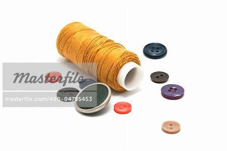 Many tools for handicraft ( thread,many buttons) on the white background