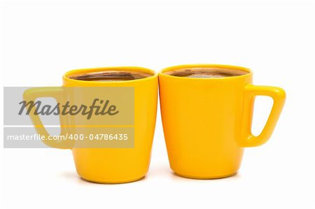 two yellow mugs of coffee on a white background