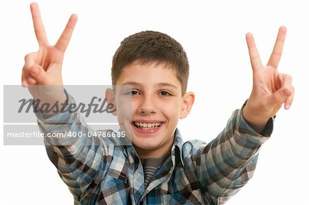 A  portrait of a handsome boy holding victory sign over his head; isolated on the white background