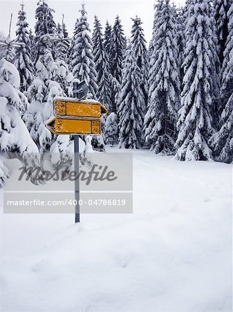 Traffic signs for cyclists covered with snow in the mountains