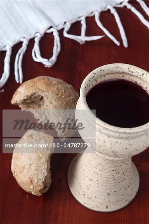 Chalice with red wine and bread. Shallow dof