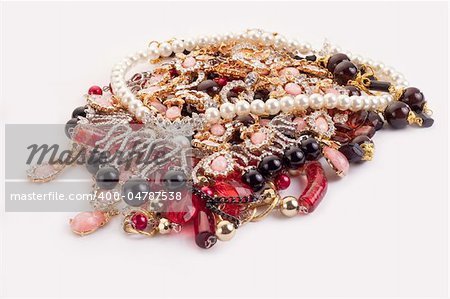 A pile of colored jewellery on white background