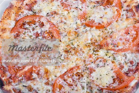 Tomato pizza with tomatoes and spicery closeup