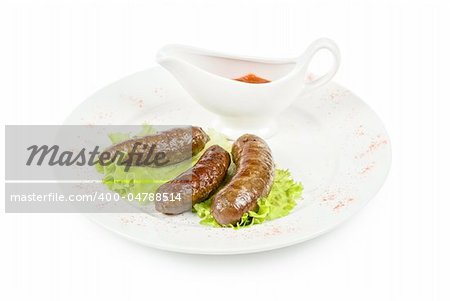 grilled venison sausage on a white with lettuce and sauce