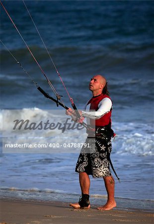 Kitesurfer with surferboard on the beach