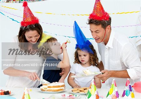 Beautiful mom serving a birthday cake to her family in the kitchen