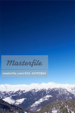Winter view of high Italian mountains and blue sky