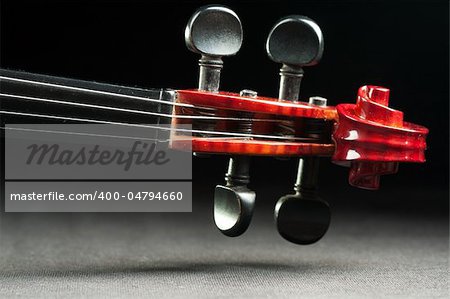 shiny violin scroll closeup on dark background