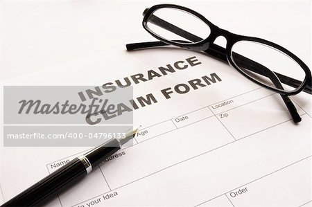 insurance claim for on desk in office showing risk concept