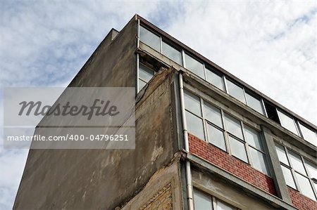 Old industrial building exterior and grungy wall.