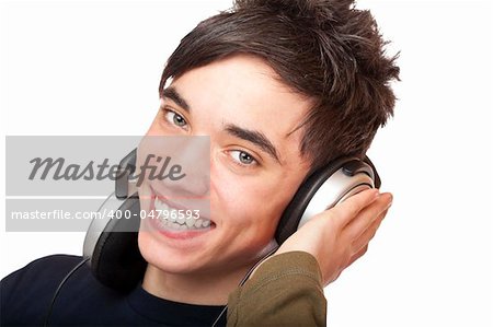 Teenager with headphones listens to music and smiles happy. Isolated on white background.