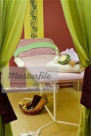 Massage room with prepared empty massage bed