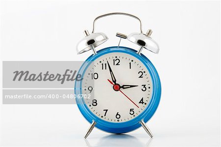 blue alarm-clock with silver bell on white background