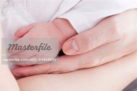 infant hand and mother hand