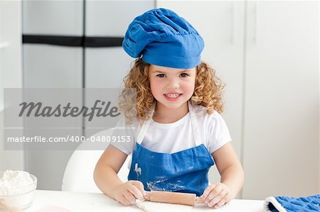 Little girl baking in the kitchen at home