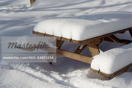 Picnic table covered in snow in city park
