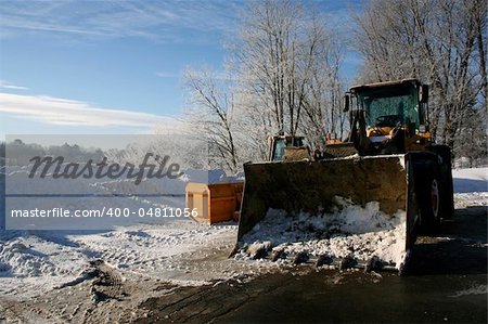 Winter heavy equipment big yellow tractor