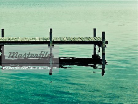 An old jetty at Starnberg Lake in Germany in an artistic color mood