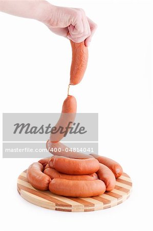 hand holding sausages isolated on white background