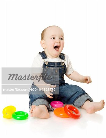 boy playing with colorful pyramid toy isolated on white