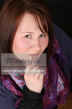 Headshot of beautiful brunette female on a black background