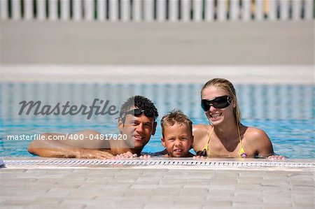 happy young family have fun on swimming pool  at summer vacation