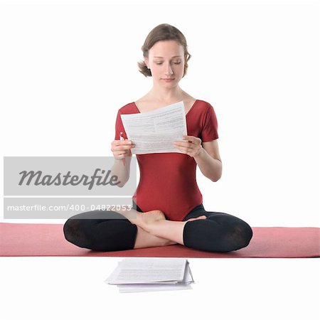 Young woman in sports clothes working with documents