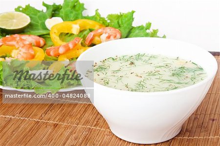 Soup with a salad on a wooden tablecloth