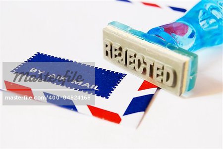 reject letter on rubber stamp with air mail envelope background