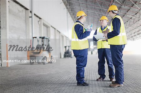 Workers talking in warehouse