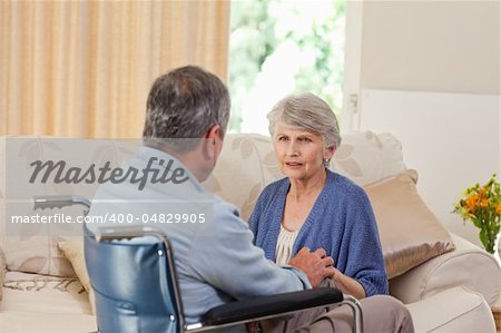 Senior couple talking in the living room at home