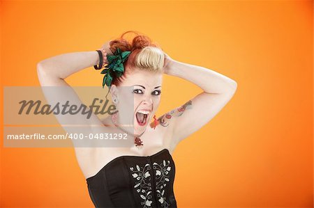 Middle-aged punk rocker in shock with hands up and shouting