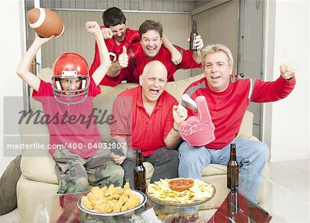 Family of football fans cheering for their favorite team.