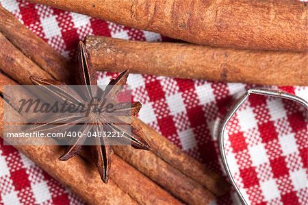 Dried Orange with cinnamon and anise on checkered cloth with cookie cutters