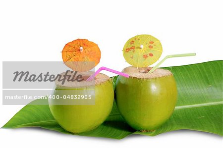 coconut beverage straw cocktail on banana leaf tender fresh coco isolated