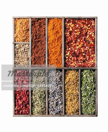 Wooden box with different herbs and spices - pepper, paprika, cumin and others