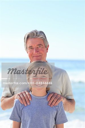 Grandfather with his grandson on the beach