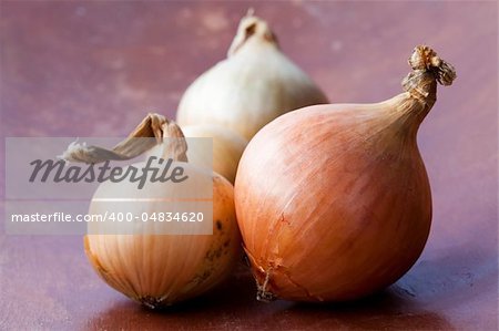 Close-up of fresh yellow onions on a wooden background