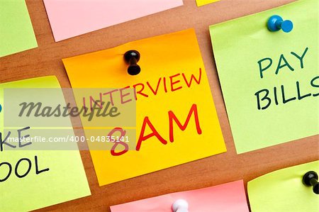 Interview reminder post it on wooden wall